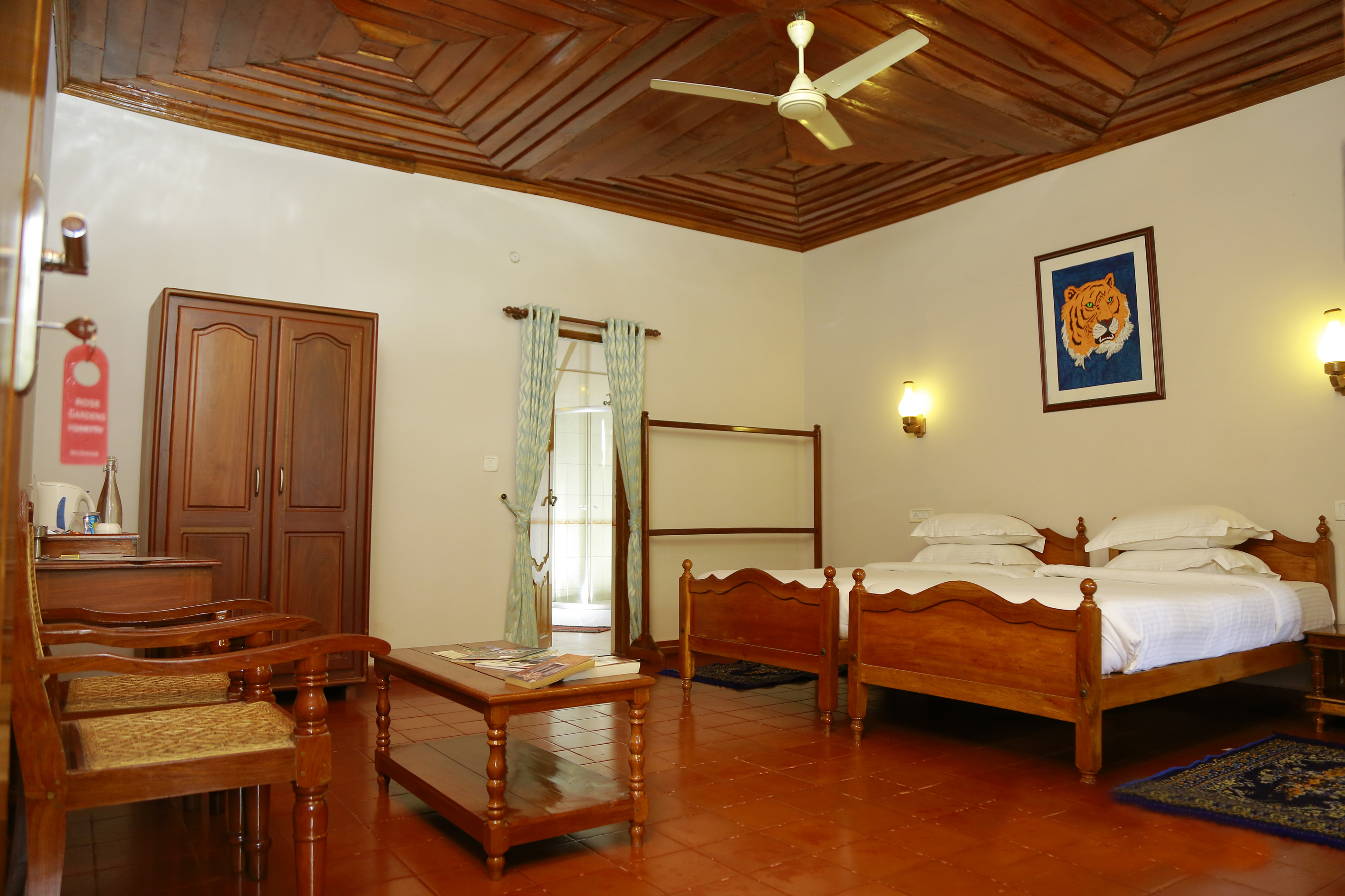 Twin-bedded double room with a wooden pitched ceiling, terracotta floor and a doorway through to the private balcony